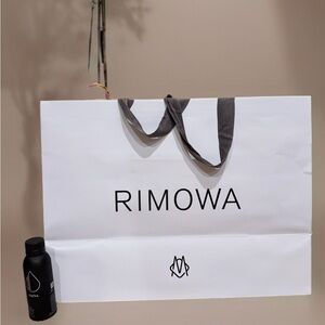RIMOWA White Paper Bag with Gray handles. Can fit carryon luggage.